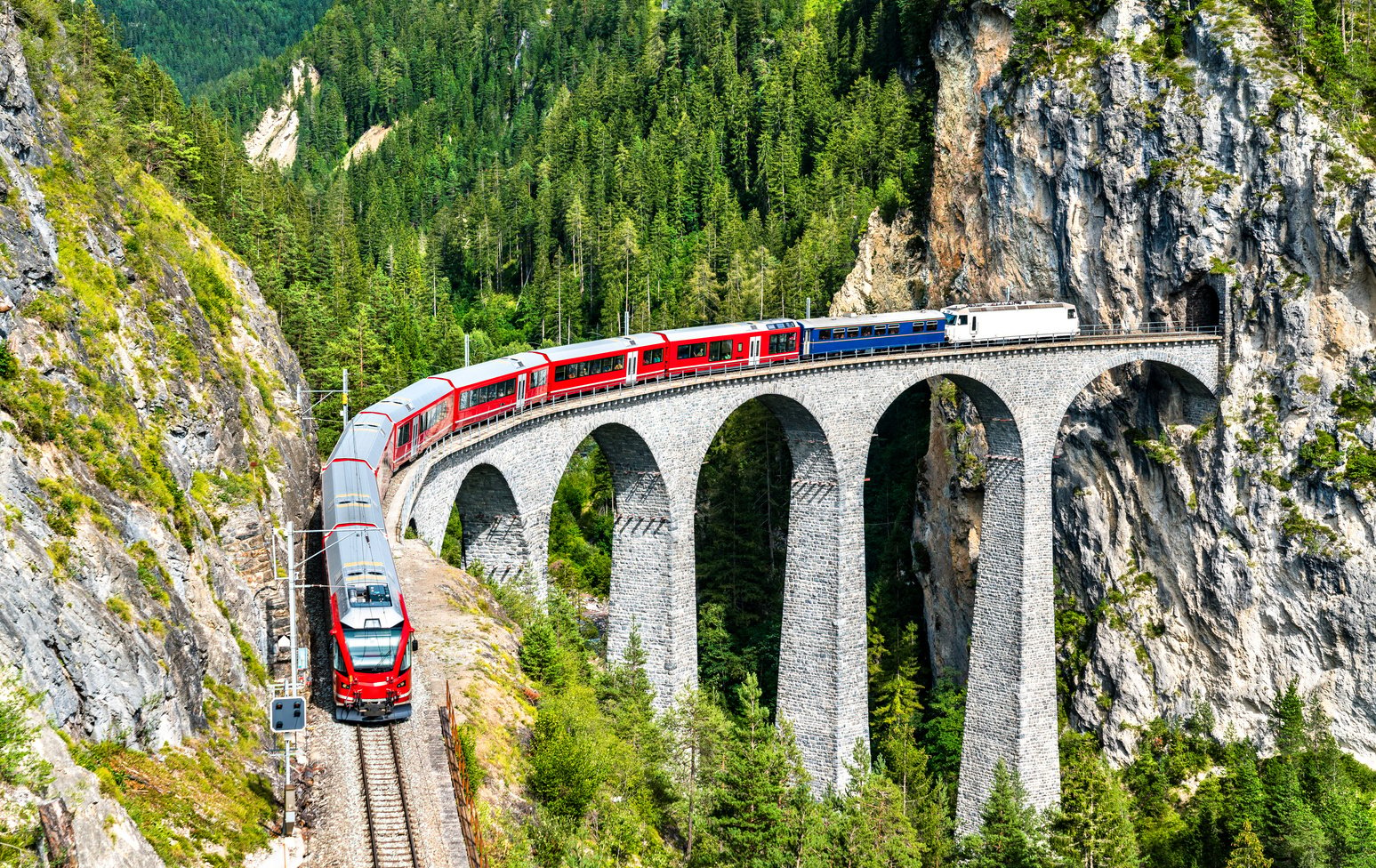 Passenger Train Crossing the Landwasser Viaduct in Switzerland